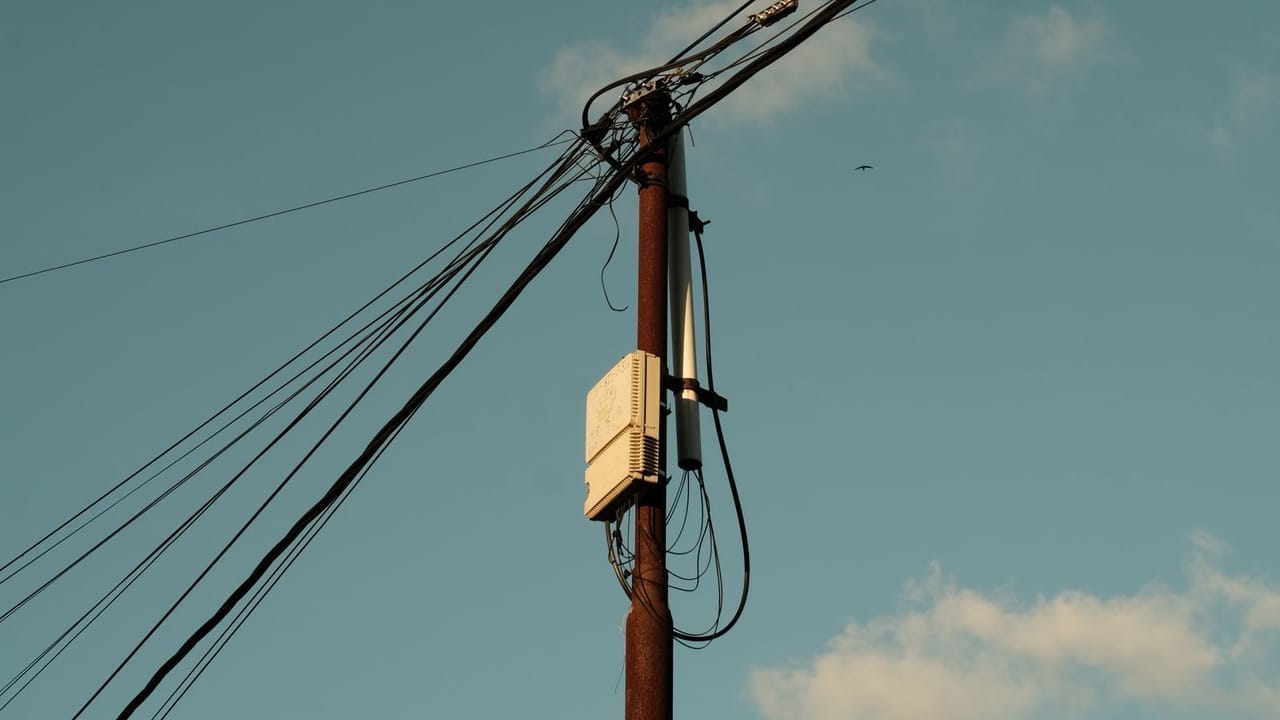 Gökyüzü önünde elektrik direği ve enerji hatları